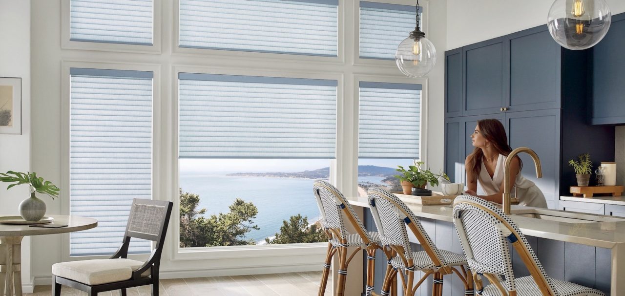 Woman in kitchen looking out the window